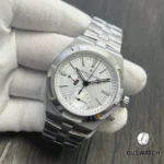 75° perspective showcasing the silver sunburst dial and case contours on the Overseas Dual Time stainless steel.