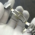 Folding clasp of the Overseas Dual Time shown unfolded to display locking mechanism, stamped markings and hinge detail.