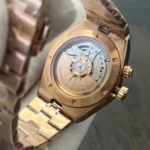 Tight view of the movement area through the caseback, emphasizing bridge decoration and rotor detail.