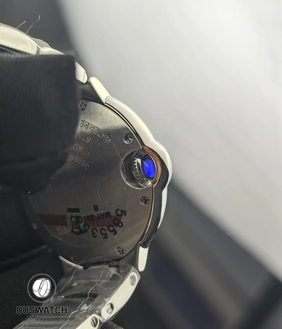 Close-up of the fluted crown and diamond detailing on the Cartier Ballon Bleu 33mm diamond-dial watch.