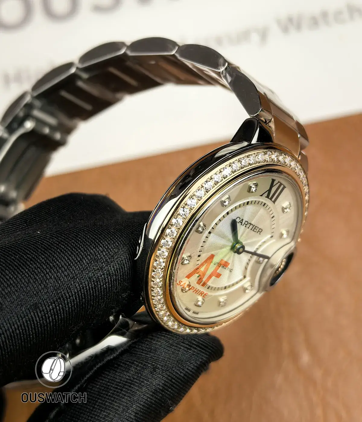 Side view showing the stainless steel case profile of the Cartier Iced Out Ballon Bleu 33mm ladies watch.