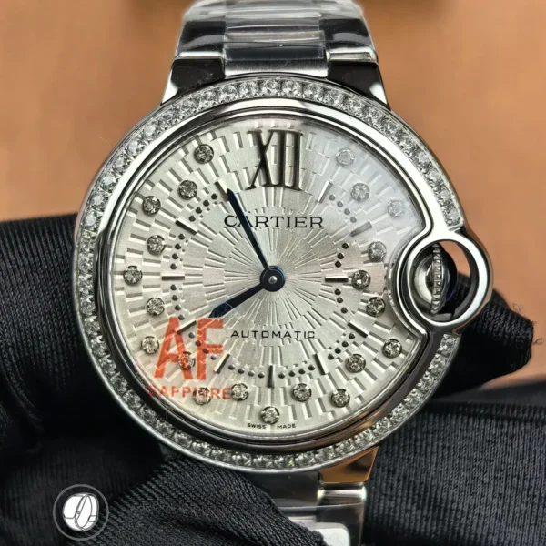 Front view of Cartier Iced Out Ballon Bleu 33mm automatic watch with silver diamond-set dial and stainless steel case.