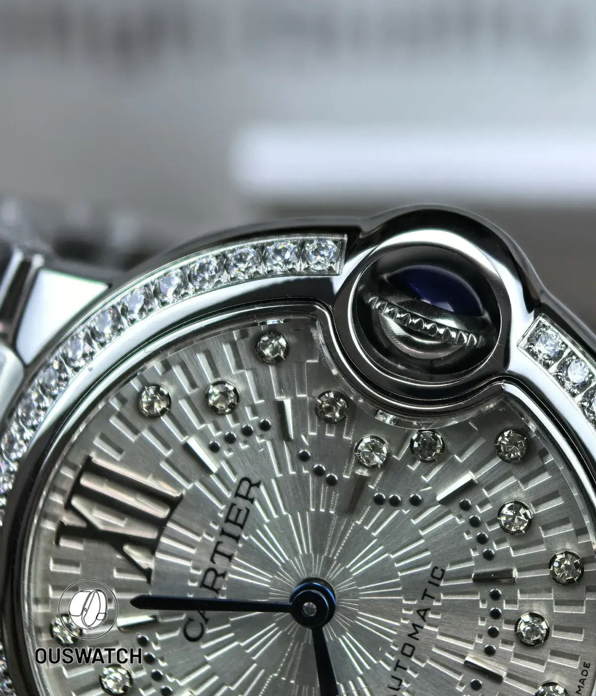 Macro of the diamond-set dial and crown assembly on the Cartier Ballon Bleu 33mm.