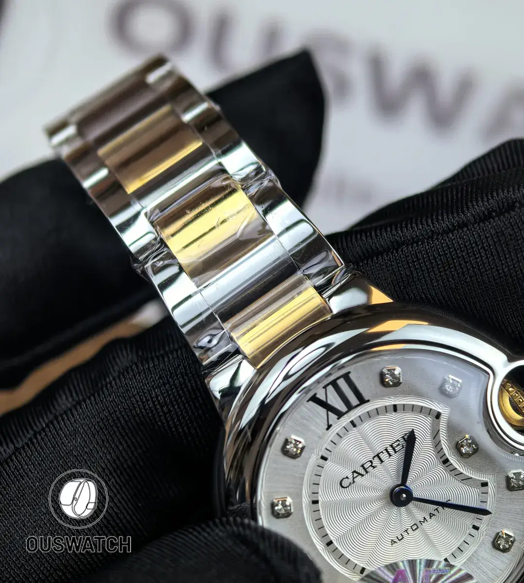 Detail shot of the rose gold and stainless steel two-tone bracelet on the iced-out Ballon Bleu watch.