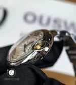 Photo focusing on the crown next to the stainless steel case, showing machining and fit.