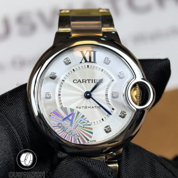 Front view of the Cartier iced-out two-tone Ballon Bleu women’s watch with a diamond-set dial and rose gold & stainless steel bracelet.