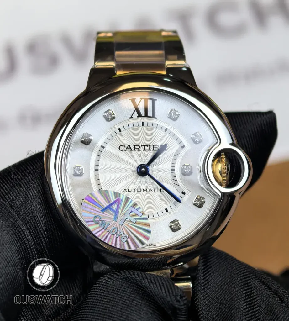 Front view of the Cartier iced-out two-tone Ballon Bleu women’s watch with a diamond-set dial and rose gold & stainless steel bracelet.