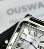 Close-up of bezel and dial showing Roman numerals and blue hands.