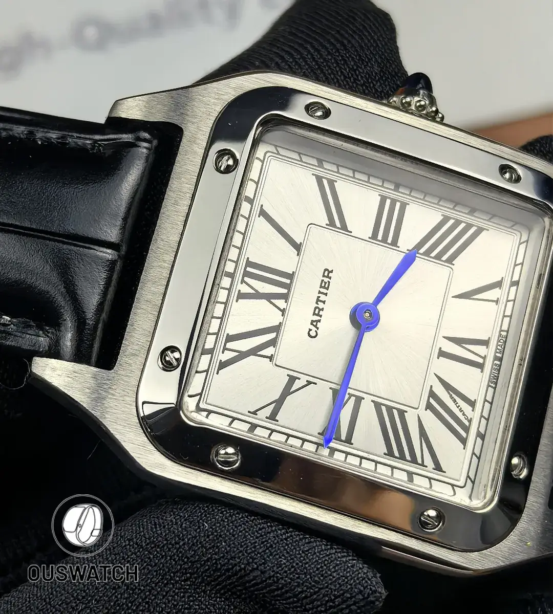 Dial close-up featuring blue sword-shaped hands and Roman numeral hour markers.