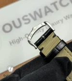 Pin-buckle clasp detail on the black leather strap.