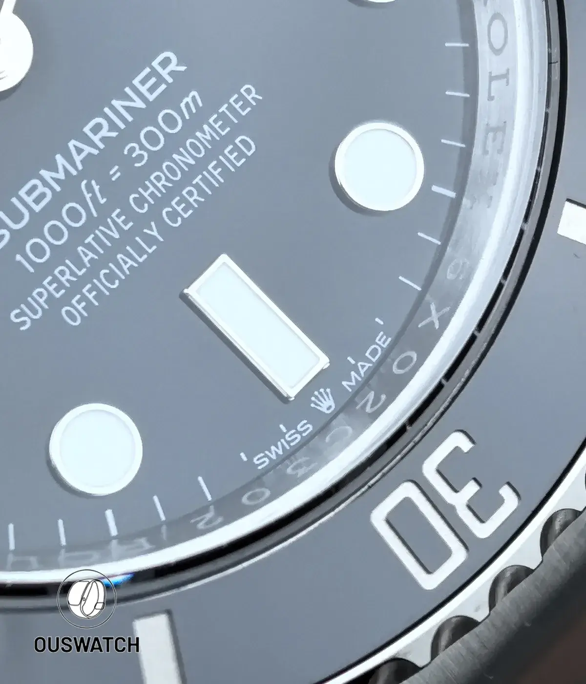 Close-up of the 6 o’clock position on the Rolex 126610LN black Submariner, highlighting the marker detail and lower dial printing
