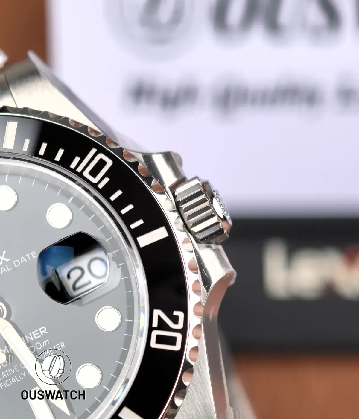 Macro shot of Rolex 126610LN dial and date window, focusing on the Cyclops lens, hour markers, and dial texture