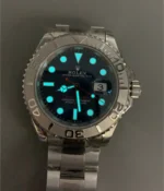 Low-light lume display of the Rolex Yacht-Master 40 blue dial, highlighting luminous hour markers and hands.