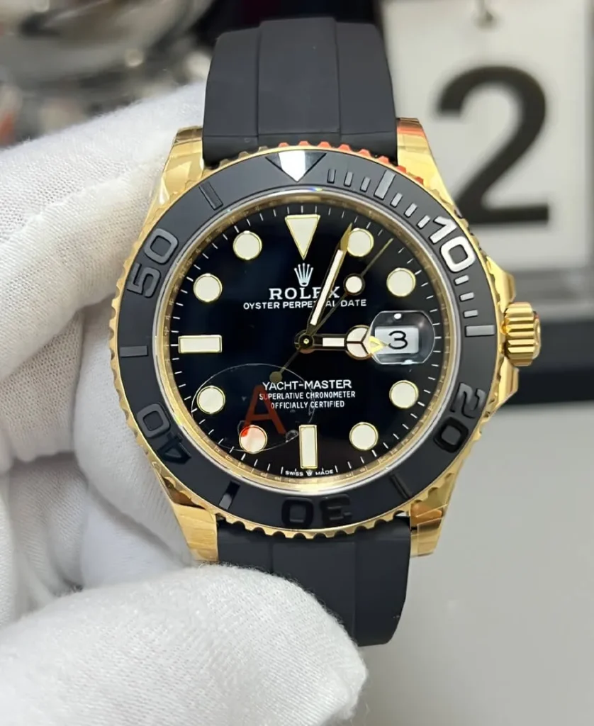 Front view of the Rolex Yacht-Master 42 super clone ref. 226658 with black dial, yellow-gold tone case, and Oysterflex-style strap.