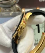 Side detail of the yellow-gold tone case and crown on the Rolex Yacht-Master 42 super clone, showing crown shape and case finishing.