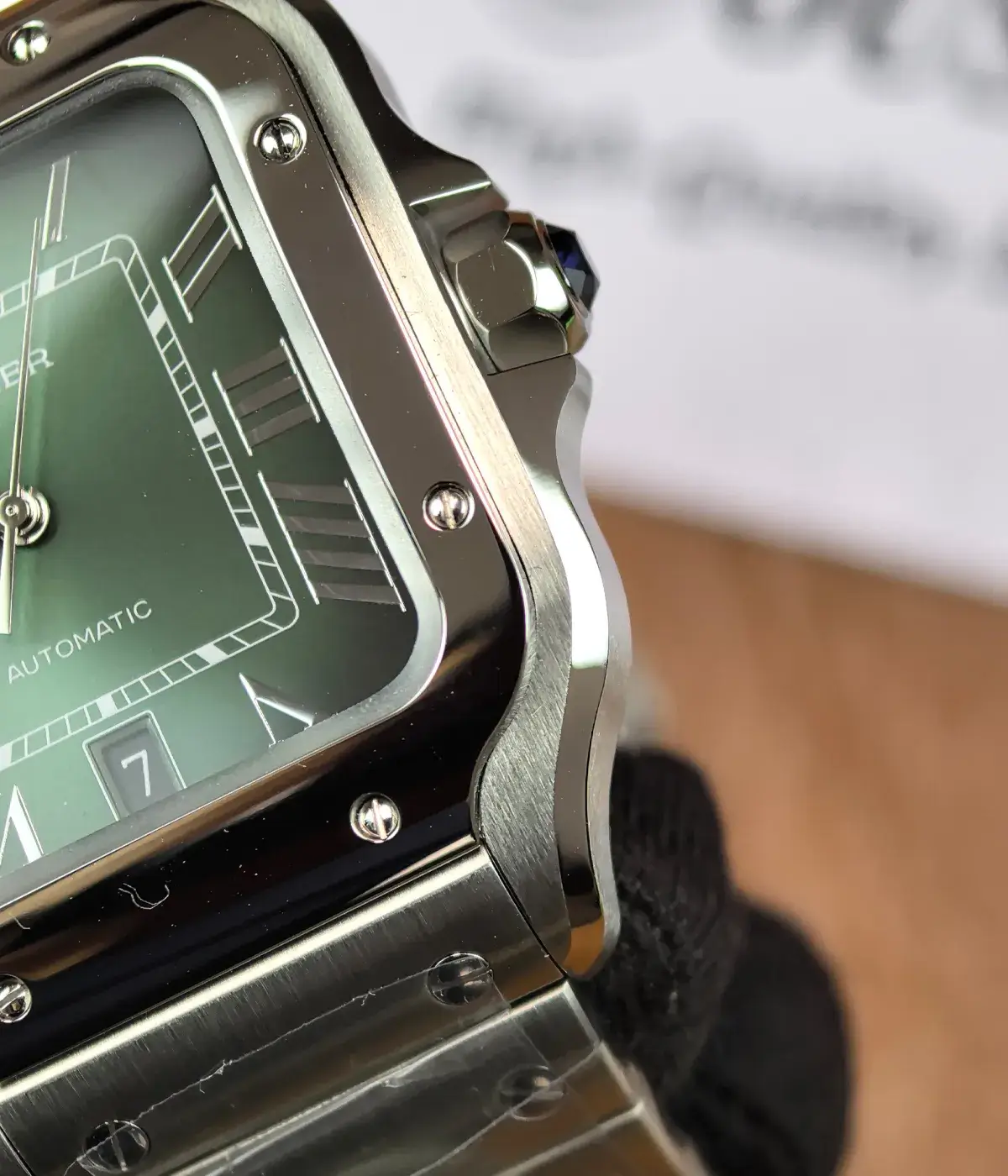 Close-up of the bezel on the super clone Cartier Santos Green Dial WSSA0062