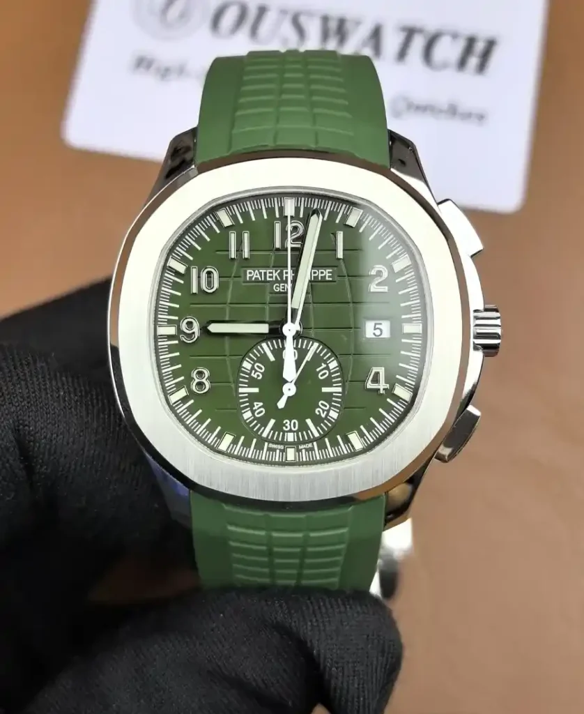 Front-facing image of the Patek Philippe Aquanaut 5968G-010, highlighting its rich green embossed dial, rounded octagonal bezel, and sporty chronograph layout.
