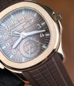 Macro view of the lower dial register at 6 o’clock, revealing the texture of the brown dial and the refined layout of the travel time display.