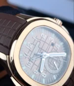 Detailed close-up of the rose gold bezel, highlighting the smooth contours, polished finish, and the sporty elegance of the Aquanaut case design.