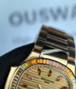 Close-up of the dial logo and textured rose gold dial details.
