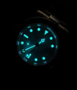 Night lume display effect of the Rolex meteorite GMT watch showing illuminated hands and hour markers.