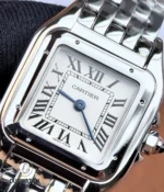 Detailed dial view of the Cartier Panthère WSPN0013 featuring Roman numerals, blue hands, and minute track.