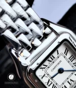 Macro shot of the Cartier Panthère WSPN0013 showing the connection between the lugs and stainless steel bracelet.