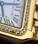 Close-up of the Cartier Panthere yellow gold bezel with diamond-set detailing.