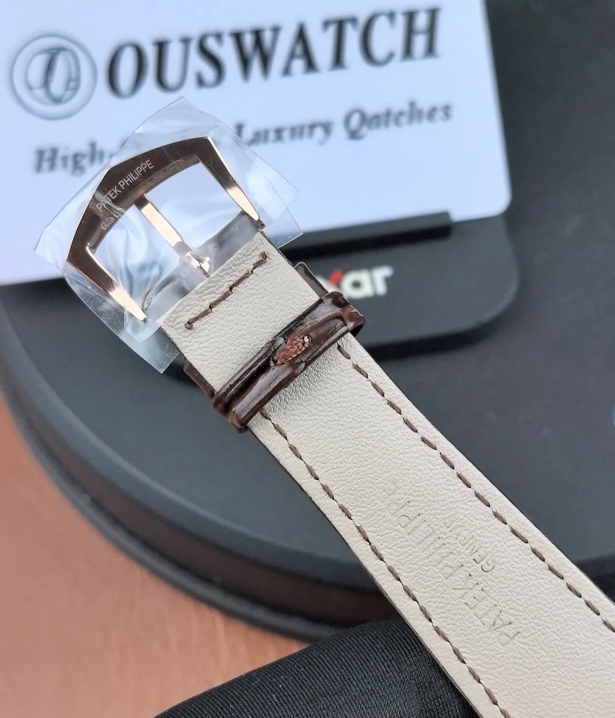 Close-up of the logo on the inner side of the strap of the Patek Philippe Calatrava Ref. 6119R.
